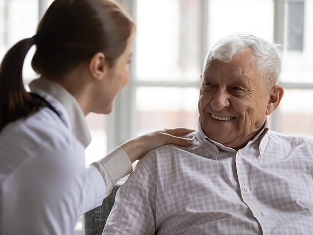 An elderly patient with a caring nurse