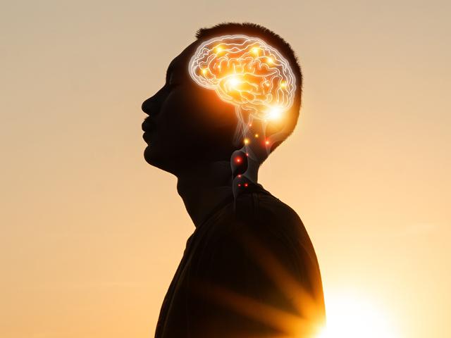 A side profile of a man with his brain illuminated