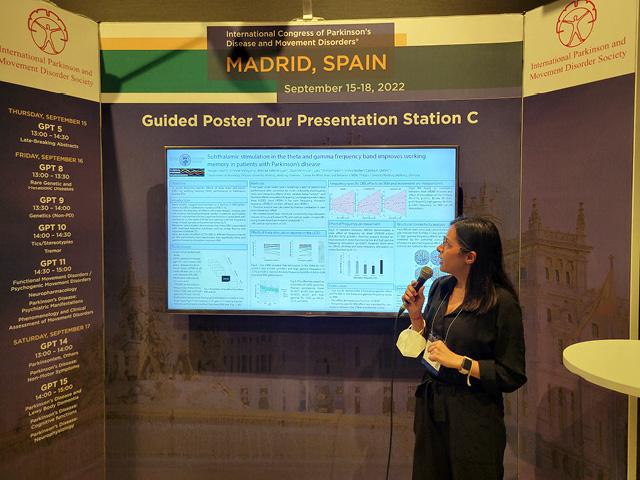 A scientist speaking about her data at a conference 