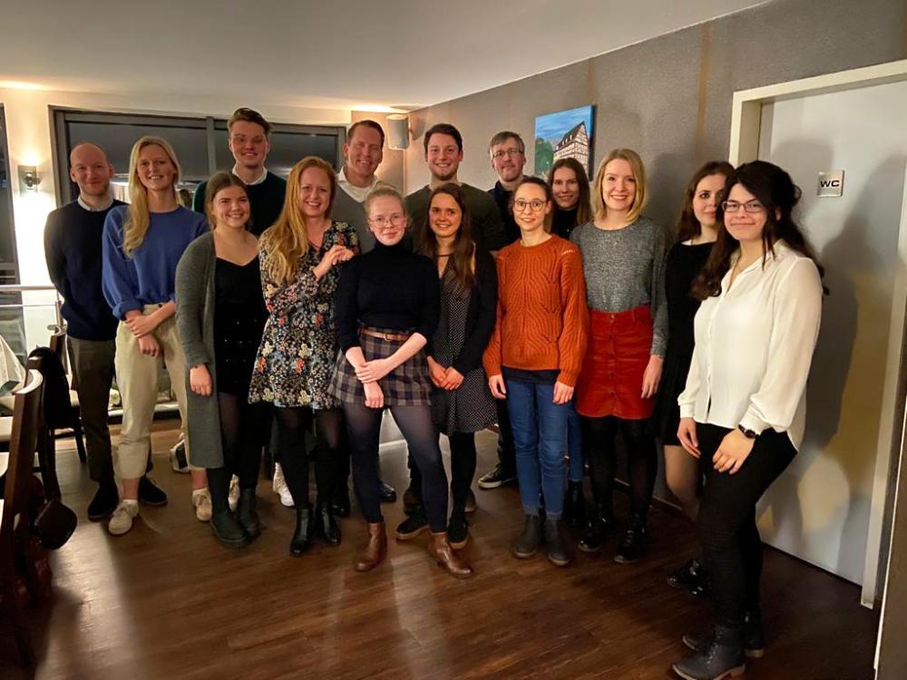 A group of people posing for a photo at a holiday party