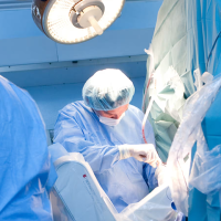 A surgeon performing surgery in an operating room